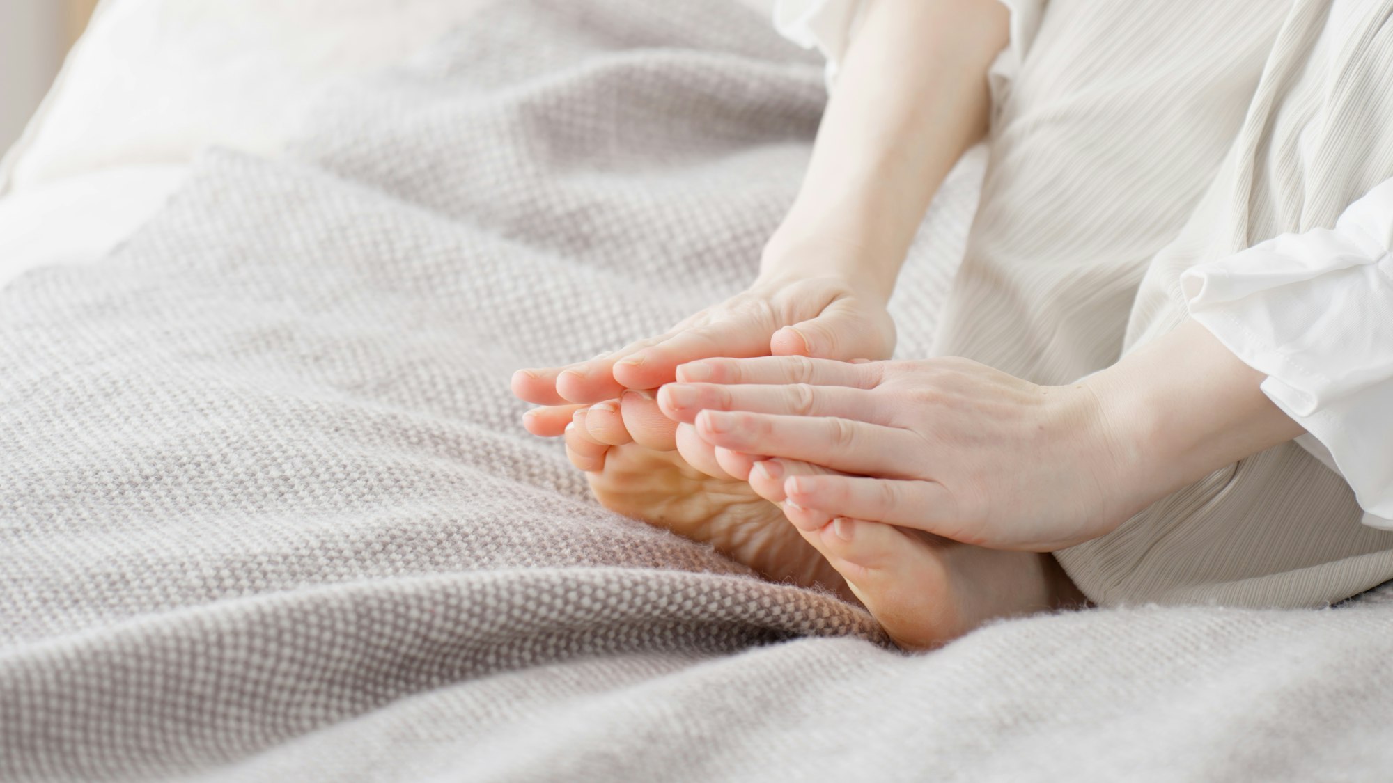 A woman rubbing her cold feet