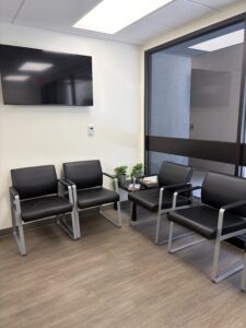 Glendale Clinic Waiting Area -vinyl chairs with wood floor, white wall and large window