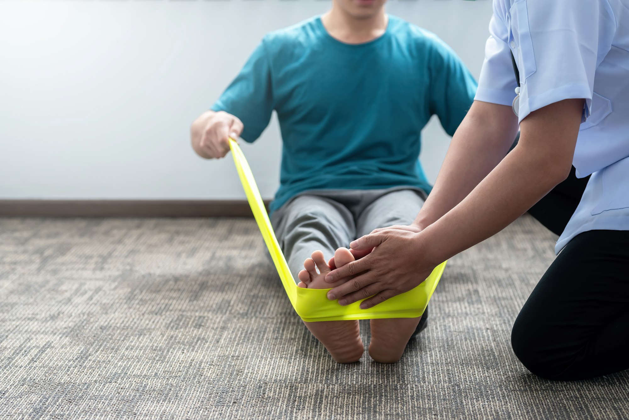 Close-up of a man practicing physical therapy at a clinic.