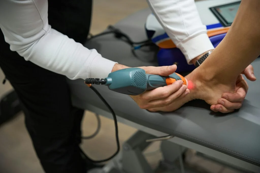 Doctor performing treatment with ultrasound machine in hospital