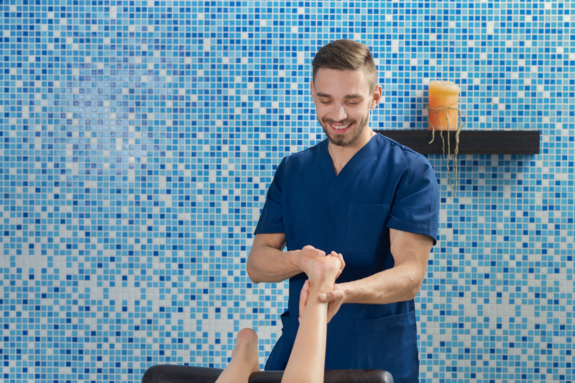 male doctor treating feet in clinic