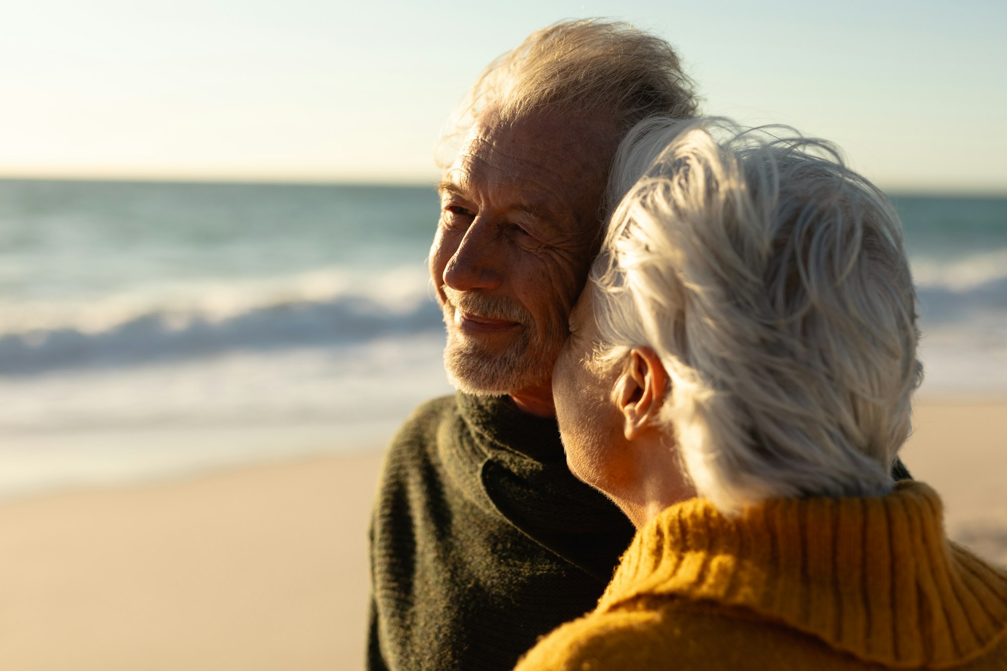 Old couple relaxing at the beach