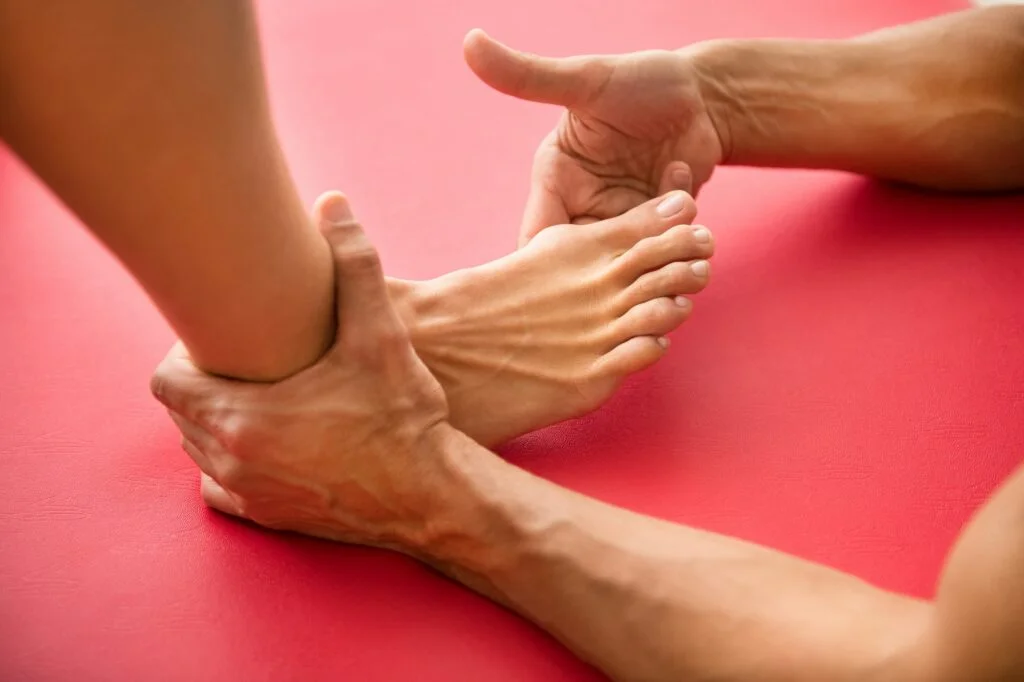 Osteopath assessing a hallux valgus. Bunion correction