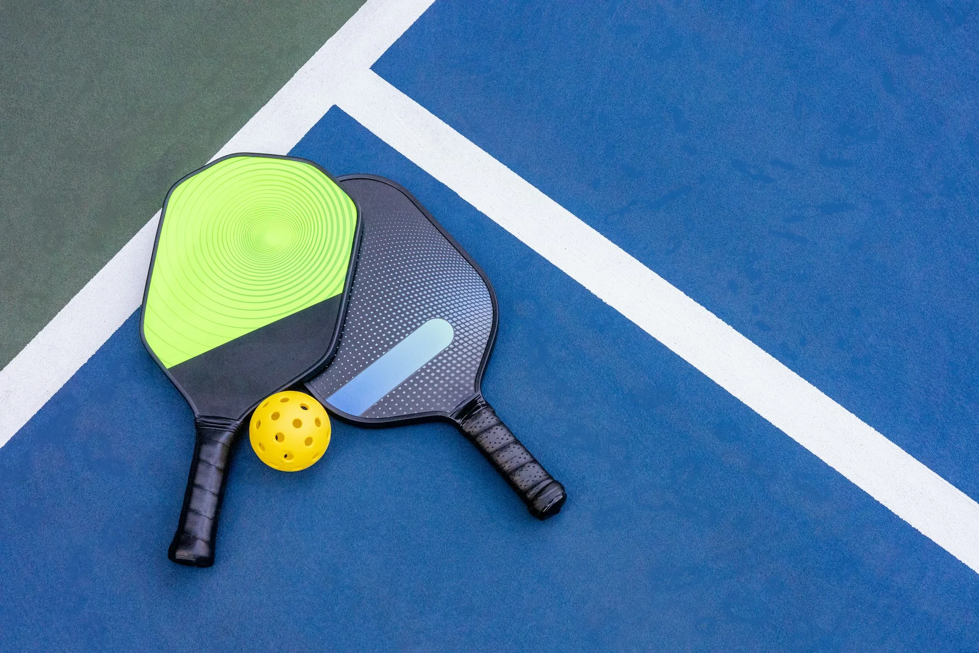 Pickleball Racquet's on blue court