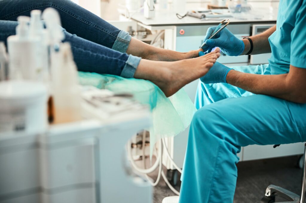 Professional doctor podiatrist doing medical pedicure procedure in the cabinet