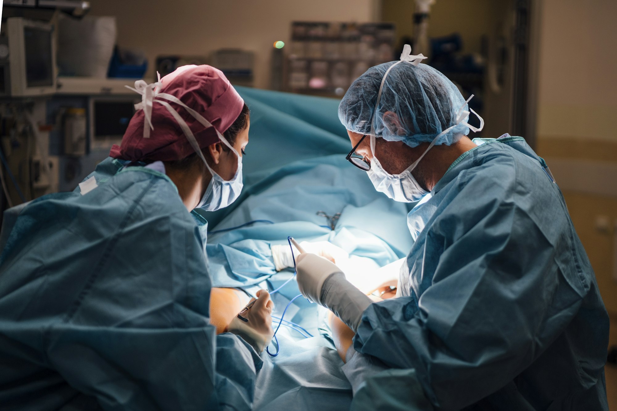 Surgeons and nurse during a plantar plate repair surgery